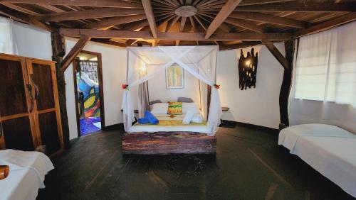 a bedroom with a bed with a canopy at Sublime Eco Hotel - Palomino Tayrona By GHO Hoteles in Palomino