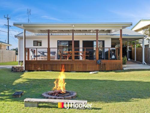 a fire pit in front of a house at Iluka Calling in Iluka