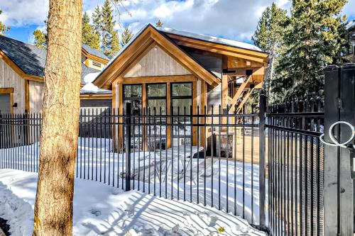 a black fence in front of a house in the snow at Breckenridge Bliss Retreat in Breckenridge