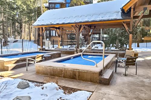 a swimming pool with a gazebo in the snow at Breckenridge Bliss Retreat in Breckenridge