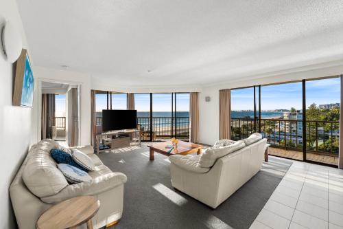 a living room with two couches and a television at The Rocks 8J in Gold Coast