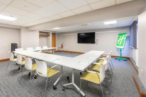 a conference room with a large table and chairs at Holiday Inn Brentwood by IHG in Brentwood