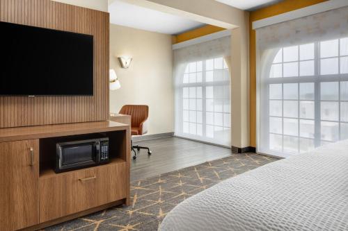 a hotel room with a flat screen tv and a bed at Holiday Inn & Suites Springfield-I-44 by IHG in Springfield