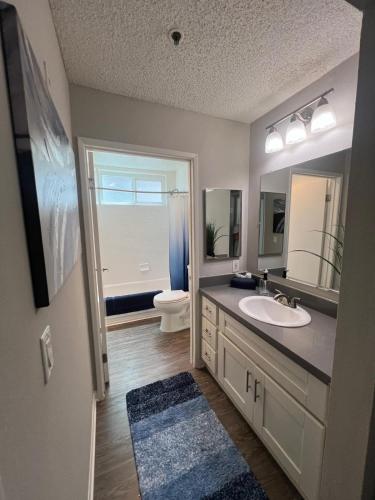 a bathroom with a sink and a toilet and a mirror at Exceptional 2 BR in Heart of Hollywood 201 in Los Angeles