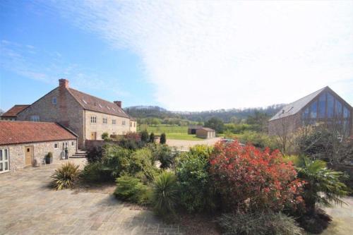 an image of a house with flowers in a yard at Luxury Barn near Wells - Pool, Gym in Wells