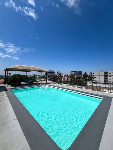 a large blue swimming pool on top of a building at Exceptional 2 BR in Heart of Hollywood 201 in Los Angeles