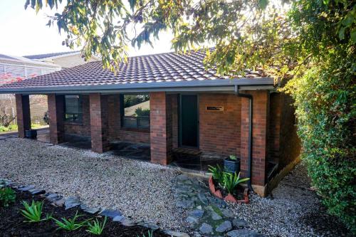 a brick house with a roof on top of it at Cakebread Cottage in Encounter Bay