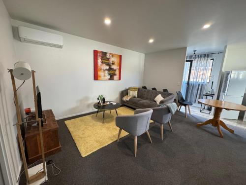 a living room with a couch and chairs and a table at 87 on FIFTH Ave in Hamilton