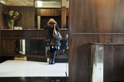 a woman standing at a counter in a building at Hotel Naples in Naples
