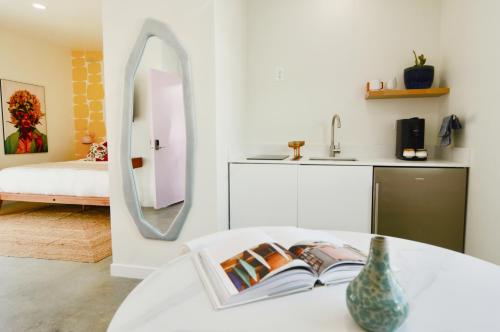 a living room with a table with a mirror at The Cactai in Palm Springs