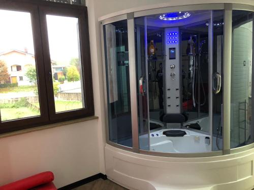 a shower in a room with two windows at B&B WELLNESS Junior Suite CAREN in Grinzane Cavour