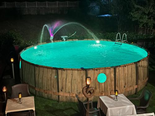 a large wooden tub with a water fountain in it at B&B WELLNESS Junior Suite CAREN in Grinzane Cavour