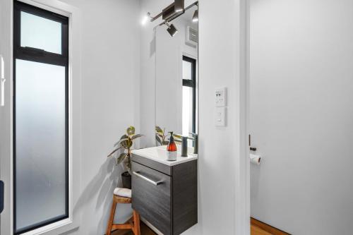 a bathroom with a sink and a window at Overdale Oasis in Christchurch