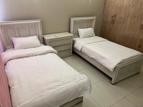 Ένα ή περισσότερα κρεβάτια σε δωμάτιο στο AQZ Apartments Three Bedroom