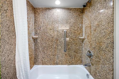 a bathroom with a shower with a tub and a sink at Quality Inn Clarksville - Exit 11 in Clarksville