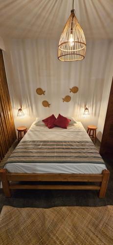 a bedroom with a bed with fish on the wall at Tapioca Vila Boutique in Atins