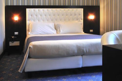 a bedroom with a large bed with a white bedspread at Hotel Naples in Naples