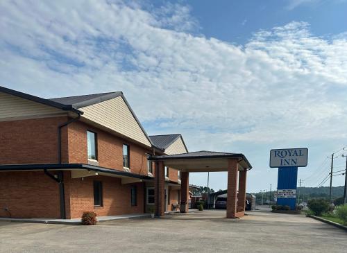 a normal inn with a sign in front of it at Royal Inn - Anniston in Anniston