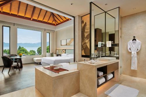 a bathroom with a bed and a sink and a mirror at Park Hyatt Ningbo Resort & Spa in Ningbo
