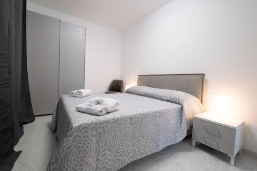 a bedroom with a bed with two towels on it at MirabiLuxury in Borgo Fosso Ghiaia
