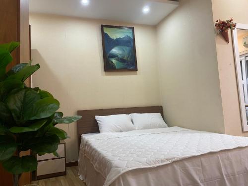 a bedroom with a bed and a painting on the wall at CHILL HOME 2 in Ho Chi Minh City