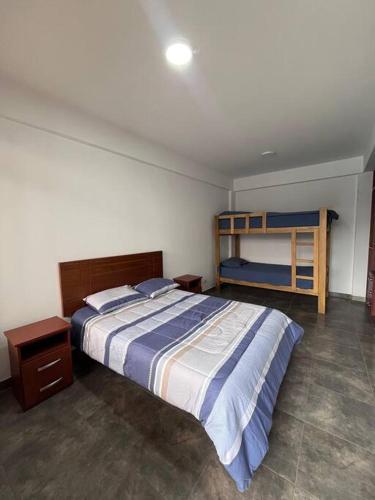 a bedroom with a bed and a bunk bed at Villa Guerrero - Casa de Campo in Larán