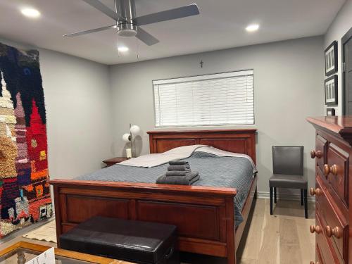 a bedroom with a bed with a ceiling fan at A Luxury Master Bedroom in a Condo in Los Angeles