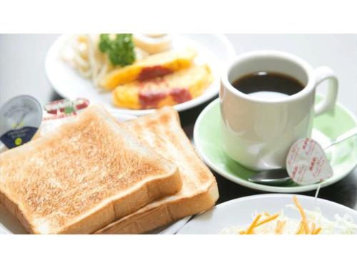 a table with two plates of toast and a cup of coffee at Sun Royal Utsunomiya - Vacation STAY 02522v in Utsunomiya