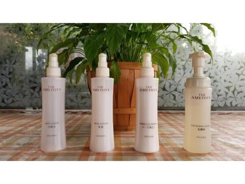 a group of four white bottles sitting on a floor at Sun Royal Utsunomiya - Vacation STAY 02522v in Utsunomiya