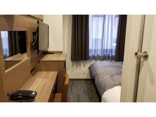 a hotel room with a bed and a mirror at Sun Royal Utsunomiya - Vacation STAY 02507v in Utsunomiya
