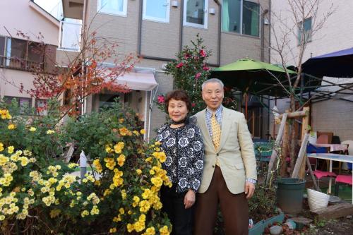 a man and a woman standing in a garden at "Cherry House" is Direct to Narita,Haneda AP, Disney, Asakusa, Skytree Tower, Tokyo in Matsudo