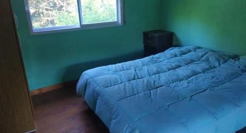 a bedroom with a large blue bed in a room at Quinta Mi angel in La Reja