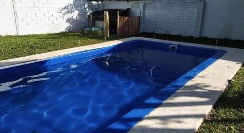a blue swimming pool in the yard of a house at Quinta Mi angel in La Reja