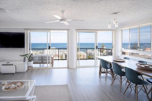 a kitchen and living room with a view of the ocean at Kings Beach Coast and Glasshouse Views - A in Caloundra