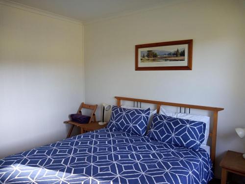 a bedroom with a bed and a picture on the wall at Crystal Springs Holiday Accommodation in Walpole