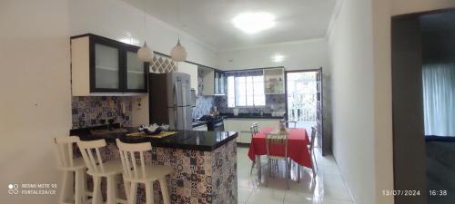 a kitchen with a table and chairs in a room at Espaço de descanso in Fortaleza