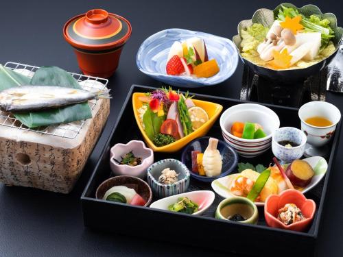 a tray filled with different types of food on a table at Ishikin in Gifu