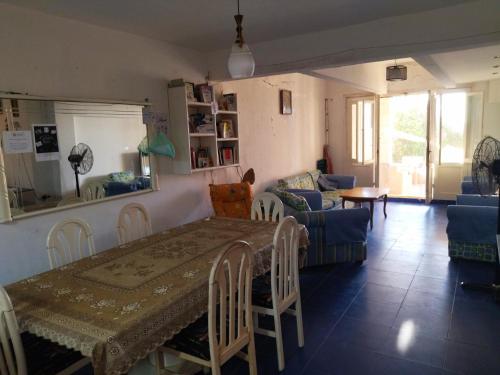 a living room with a table and a couch at Riviera Dream Chalet in Dawwār al Ḩajj Aḩmad