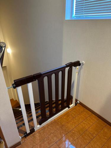 a stair railing in a room with a window at Southerlies Condominium Onna in Onna