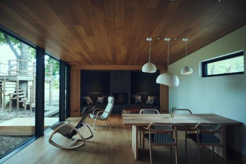 a dining room with a table and chairs at SONEKA in Kitahiroshima