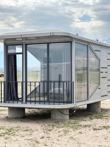 a circular building with glass doors on a field at Lake_glamping_ik in Tossor