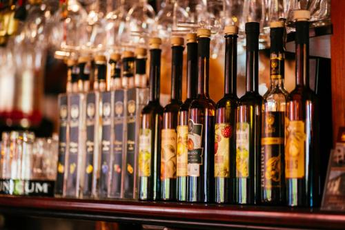 a bunch of bottles of wine on a shelf in a bar at PENSIUNEA GAMBRINUS **** in Miercurea-Ciuc