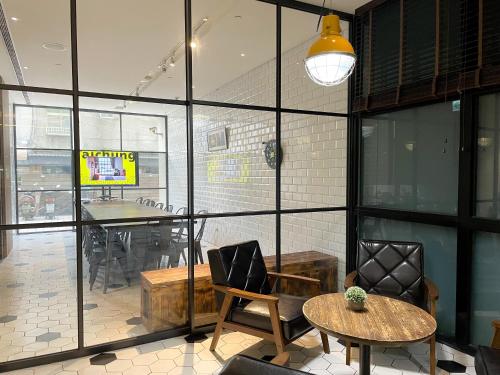 a room with a table and a chair and a table and a tablektop at CHECK inn Taipei Songjiang in Taipei
