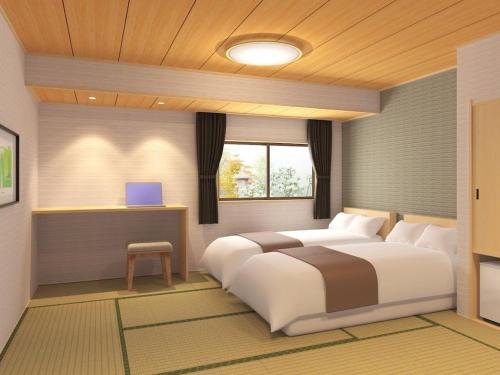 a bedroom with a large white bed and a window at Ishikin in Gifu