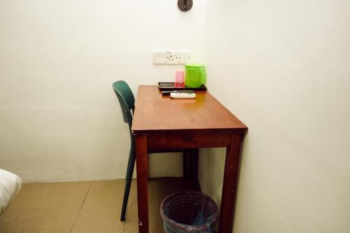 a small wooden table with a green cup on it at V Hotel Titiwangsa in Kuala Lumpur