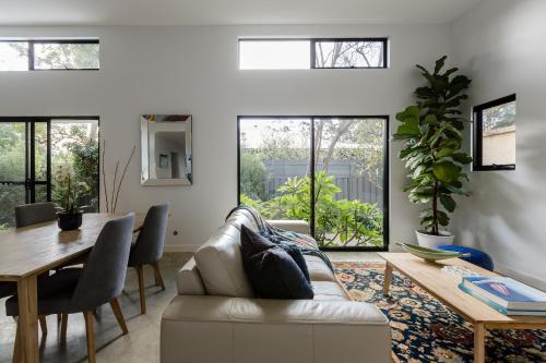a living room with a couch and a table at Marri Lodge - 2 Bedroom with Ensuites Spacious Townhouse in Margaret River Town