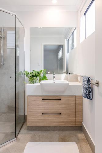 a bathroom with a sink and a shower at Marri Lodge - 2 Bedroom with Ensuites Spacious Townhouse in Margaret River Town