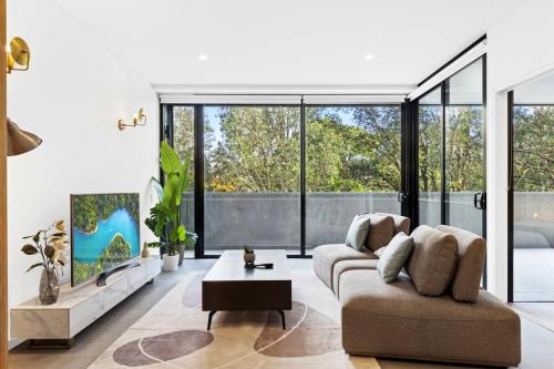 a living room with a couch and a table at Morden Urban 2Bed in Waterloo in Sydney