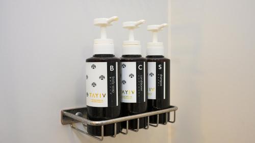a group of four bottles of wine on a shelf at Airport Hotel Kumamoto in Ozu