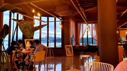 a group of people sitting at a table in a restaurant at Andante Resort in Jangheung